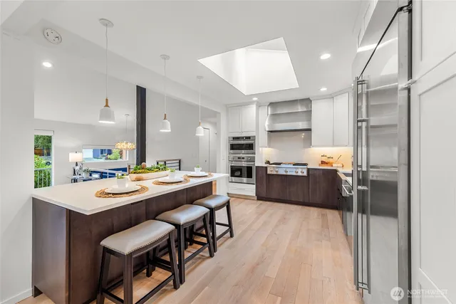 a kitchen with a sink and chairs