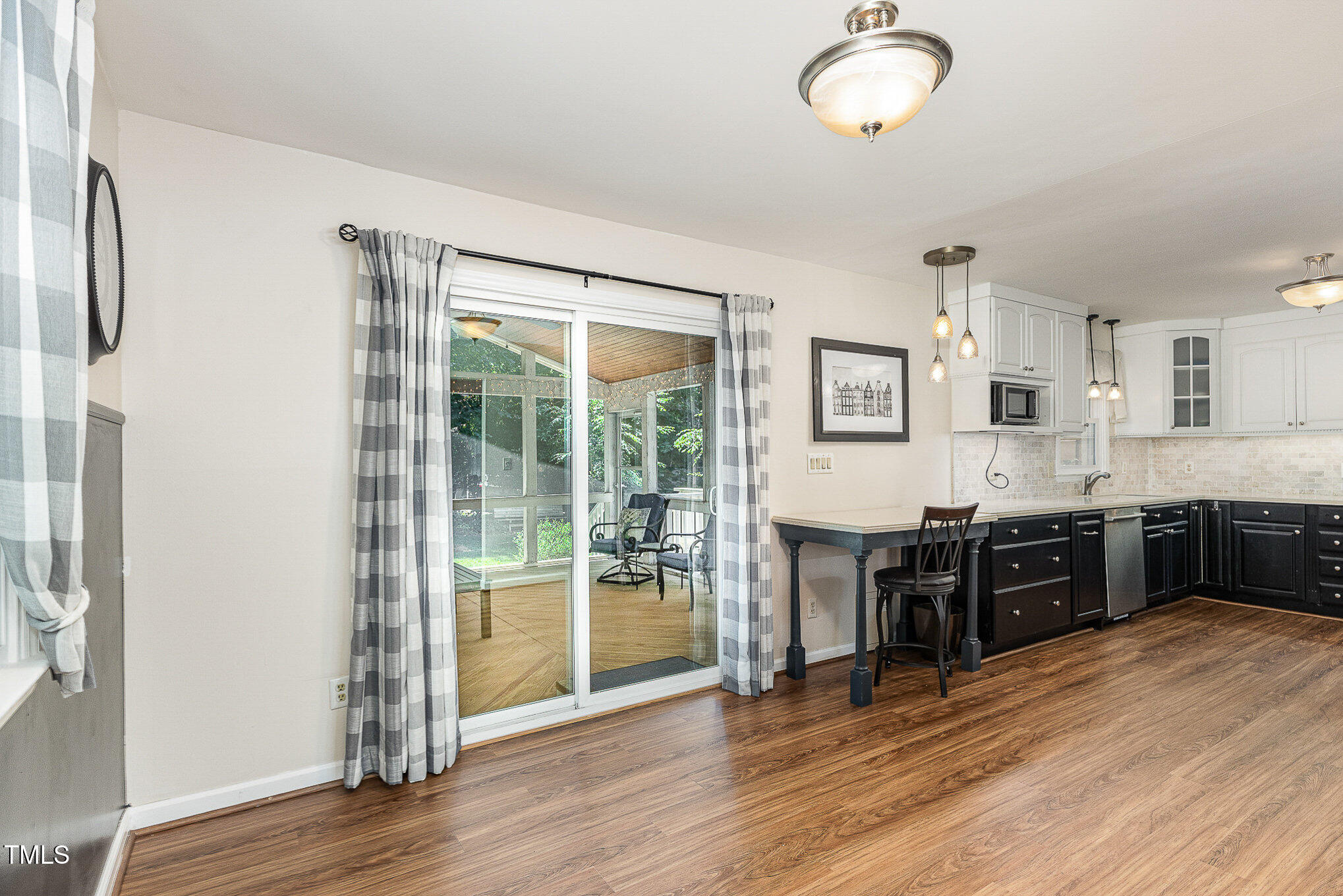 6609 Electra Drive Raleigh, NC 27607 - Photo 14 of 35 Dining and kitchen area that flow out to the screened in porch