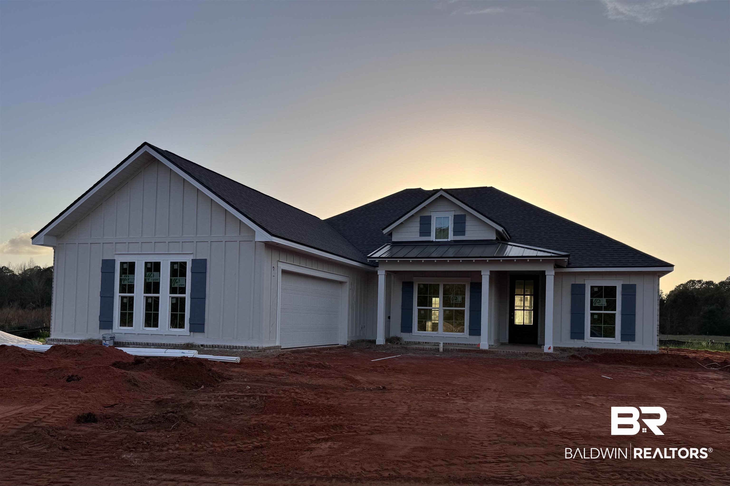 27371 Patch Pl Loop Daphne, AL 36526 - Photo 1 of 63 View of front of home with a standing seam roof, covered porch, a garage, board and batten siding, and a shingled roof