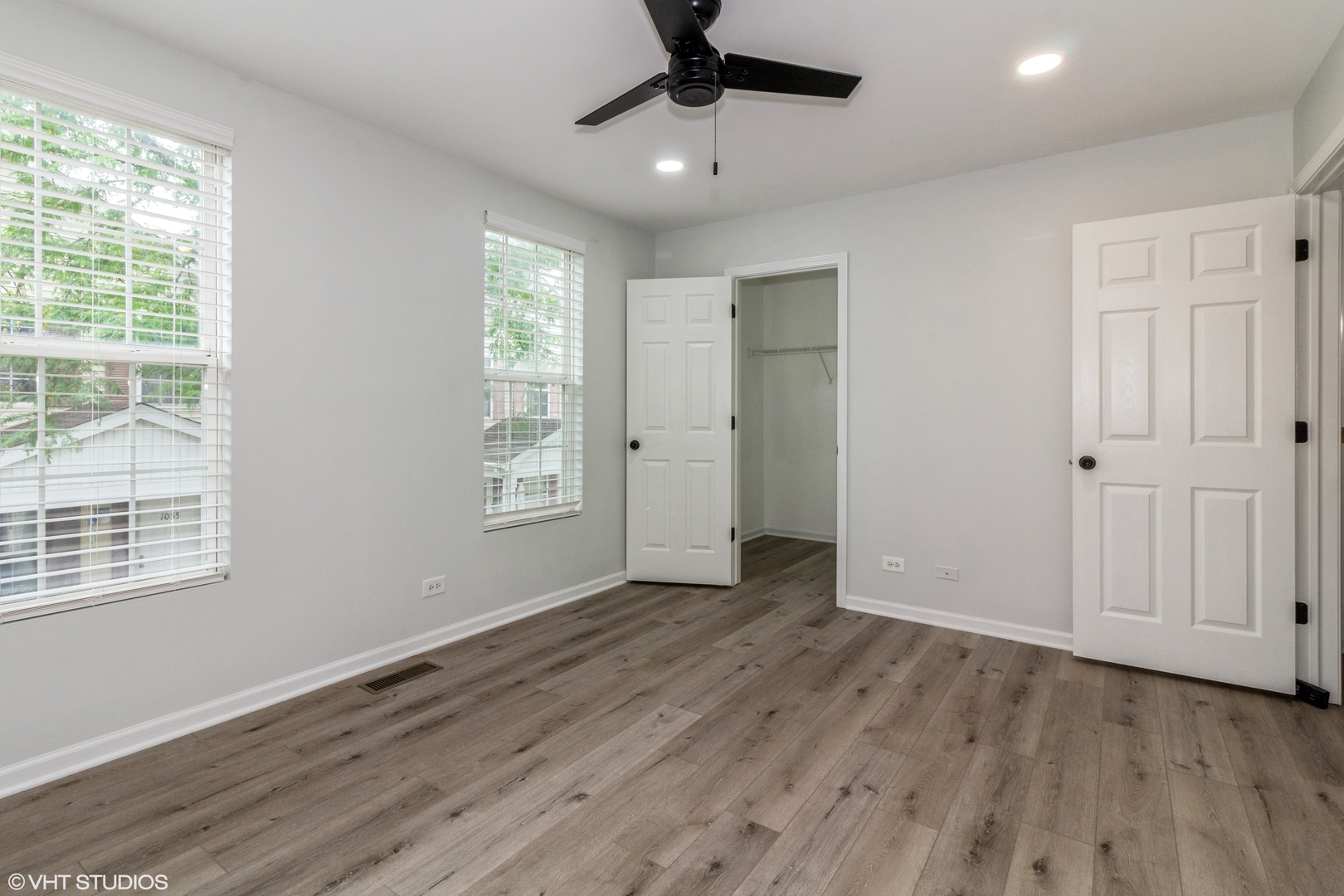 1061 Symphony Drive Aurora, IL 60504 - Photo 7 of 10 a view of an empty room with wooden floor and a window