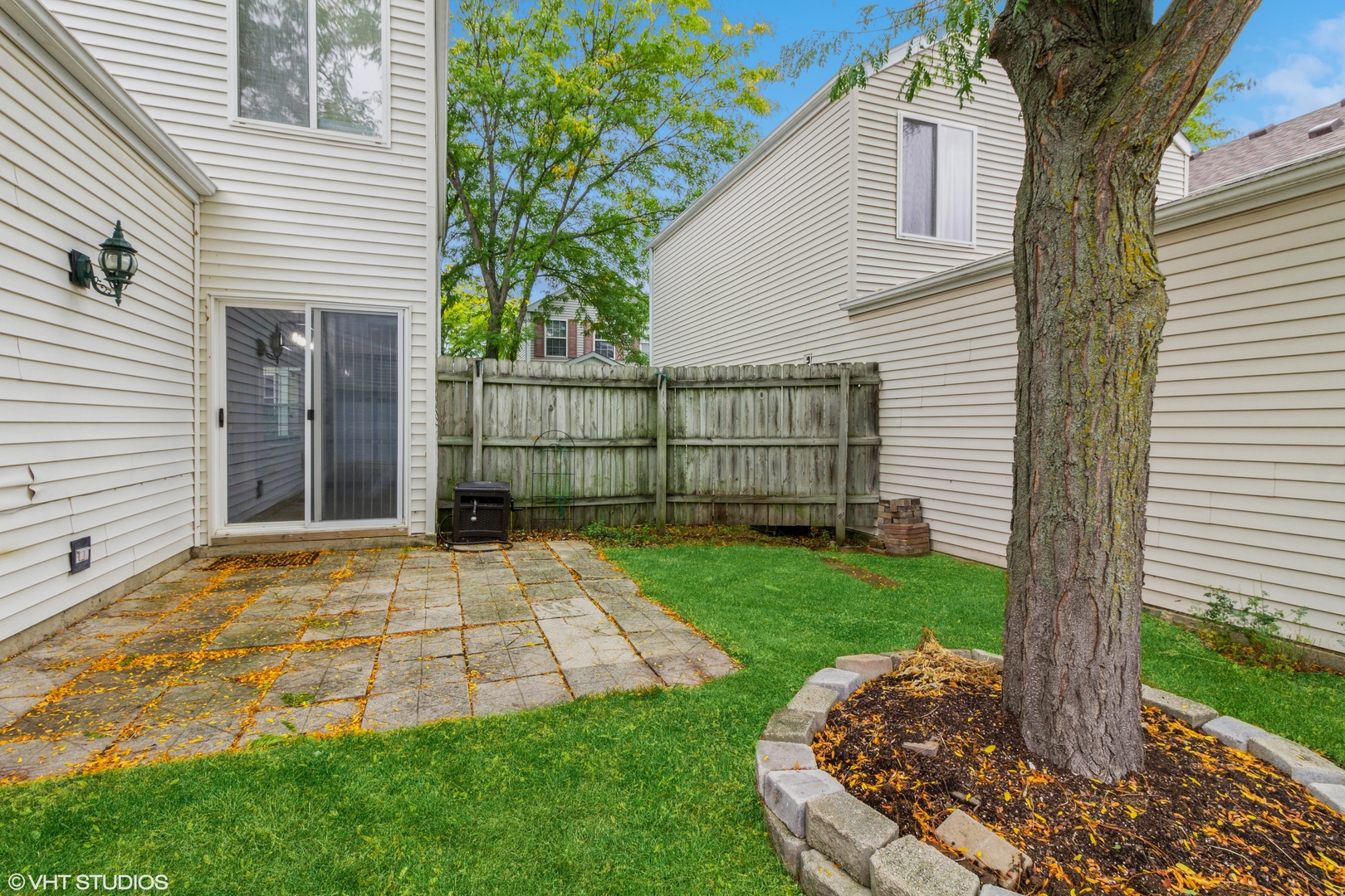 1061 Symphony Drive Aurora, IL 60504 - Photo 9 of 10 a view of a backyard with a large tree