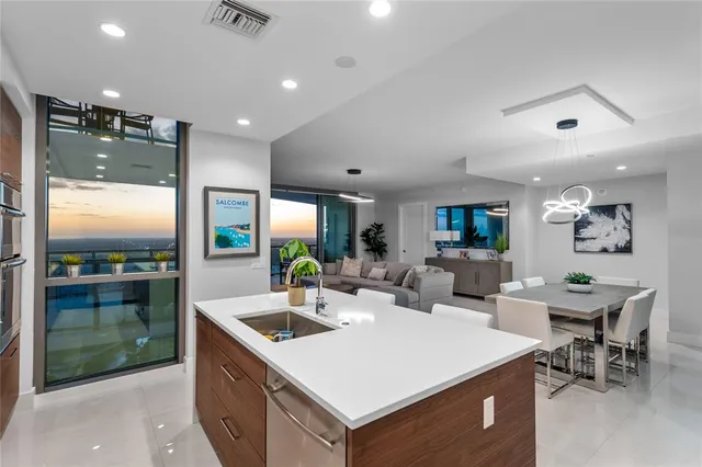 a living room with furniture a rug and a large window