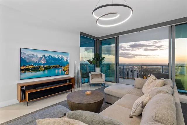 a bedroom with a large bed and a flat tv screen on dresser