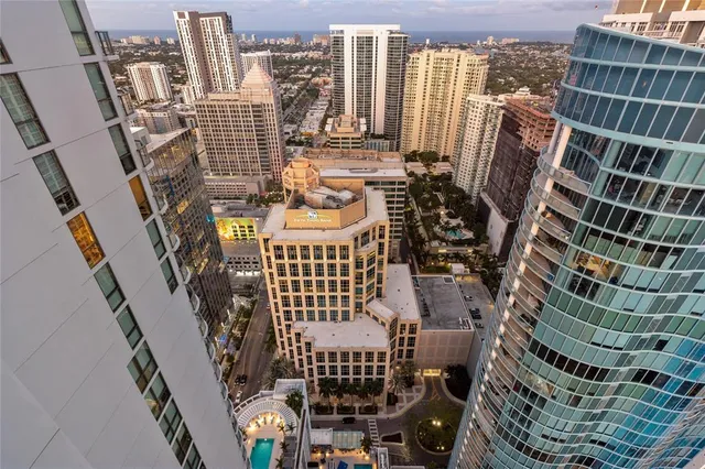 a living room with furniture potted plant and a flat screen tv