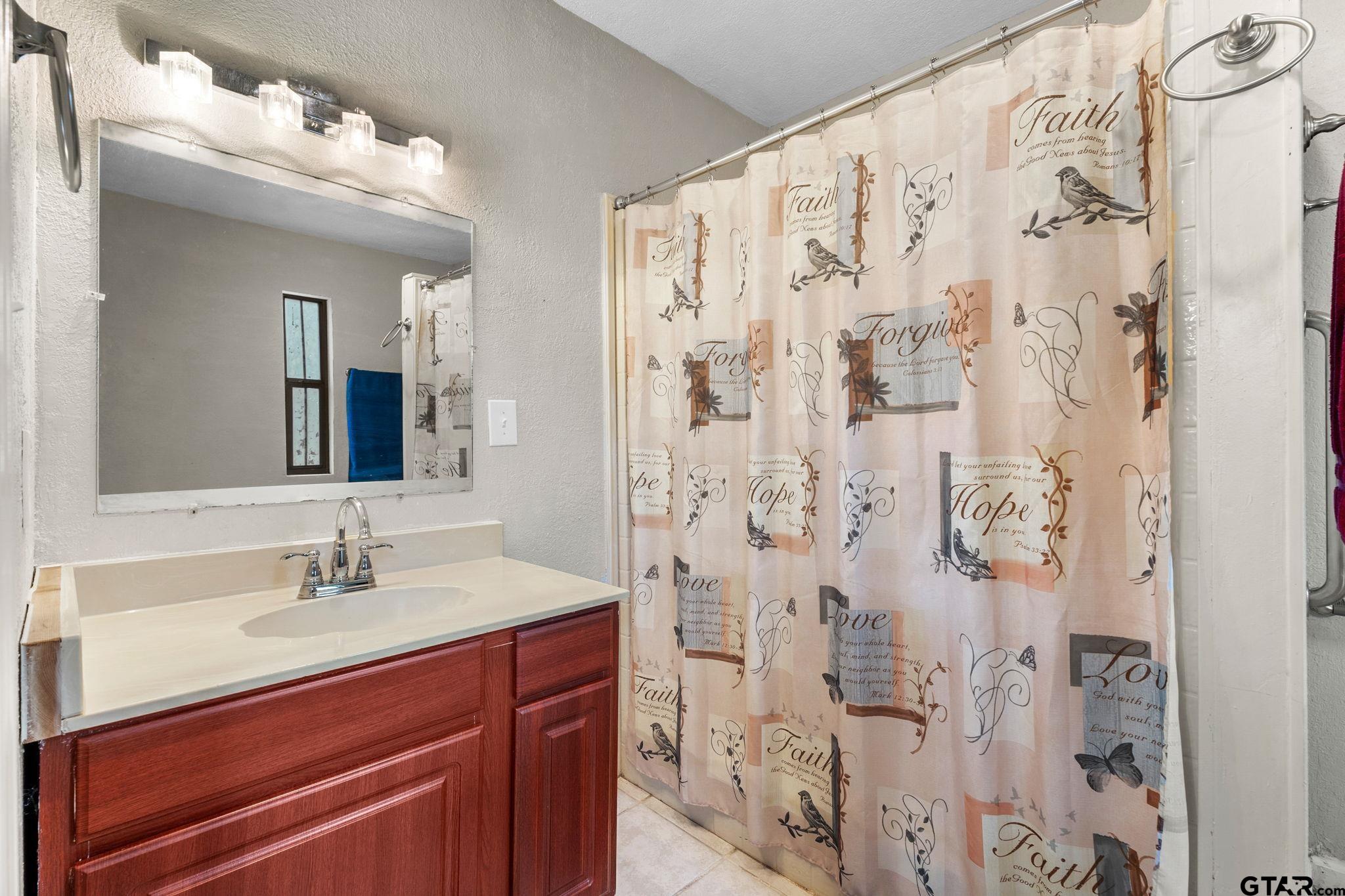 6091 Mockingbird Lane Murchison, TX 75778 - Photo 12 of 33 a bathroom with a sink vanity granite and shower