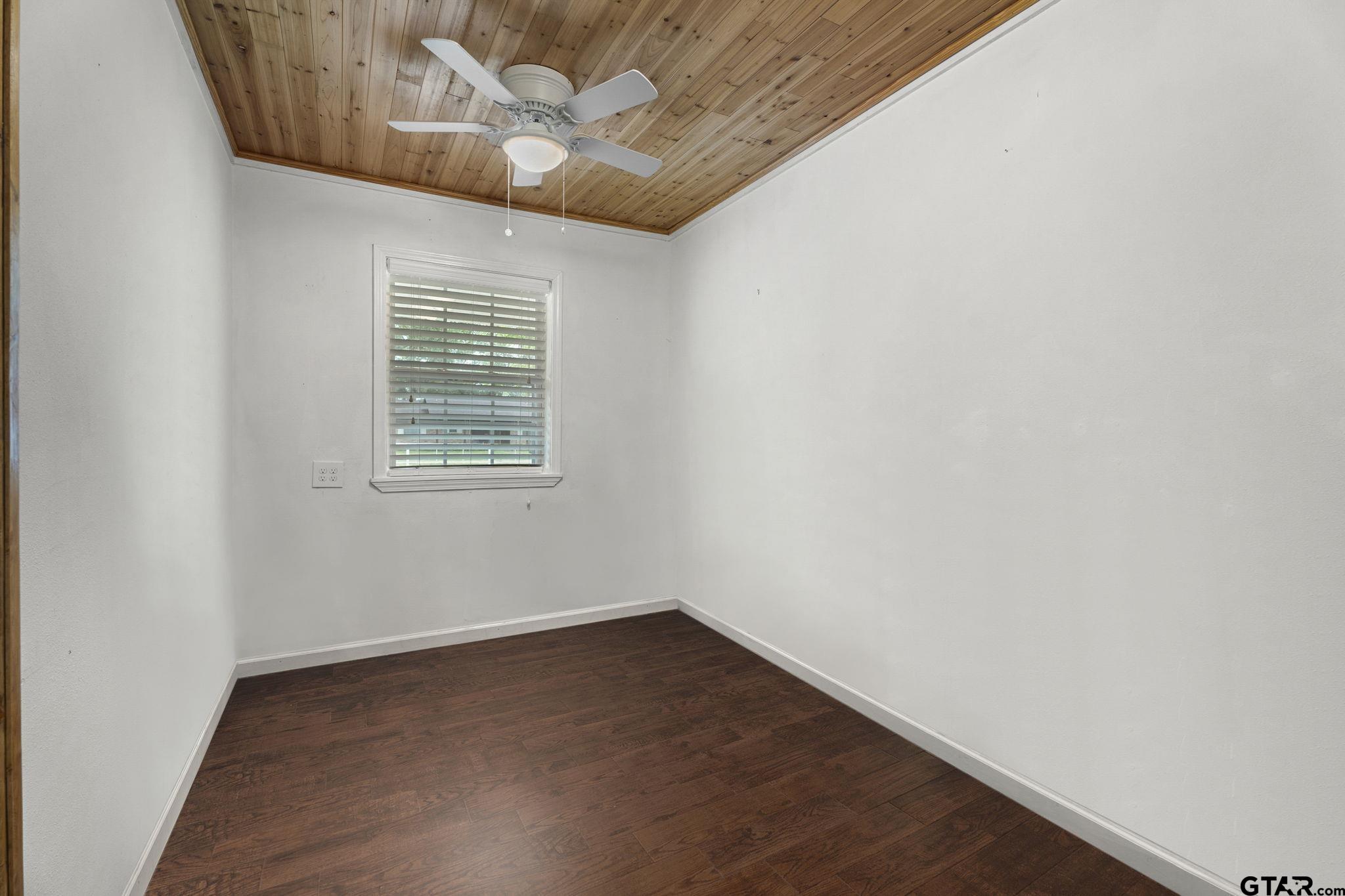 6091 Mockingbird Lane Murchison, TX 75778 - Photo 14 of 33 a view of an empty room with wooden floor and a window