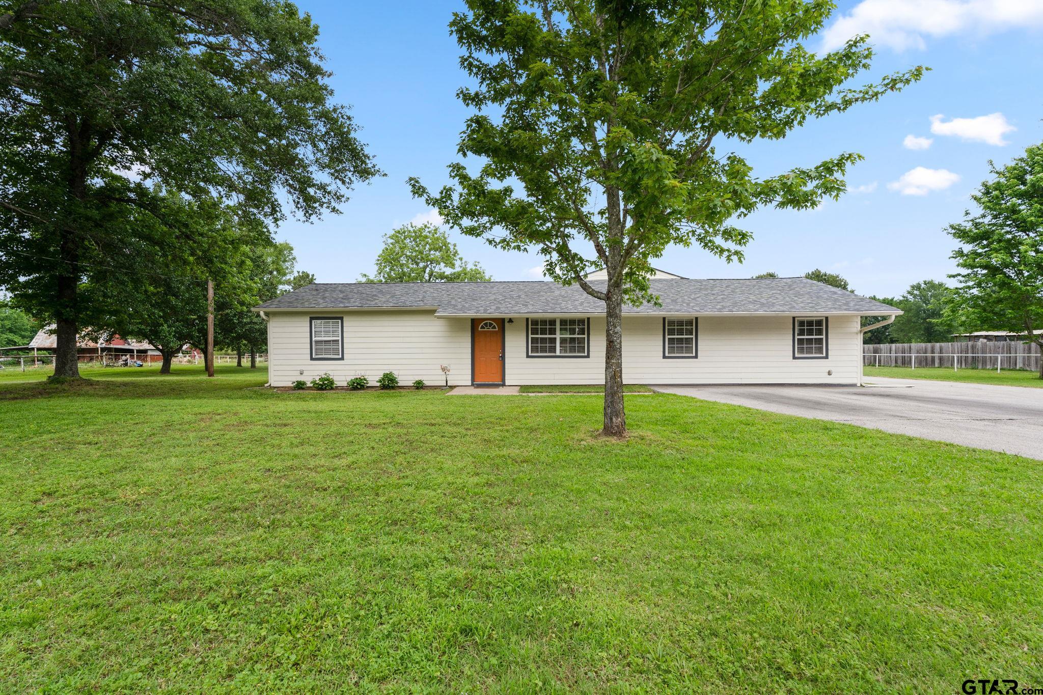 6091 Mockingbird Lane Murchison, TX 75778 - Photo 3 of 33 a front view of a house with a garden
