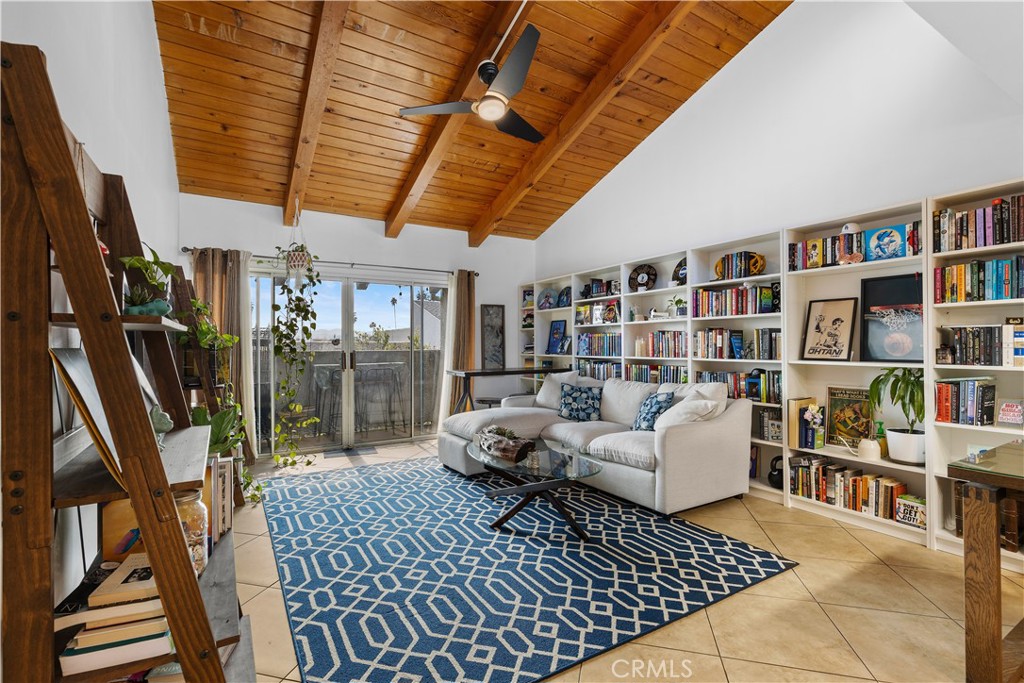 a living room with furniture a rug and a book shelf