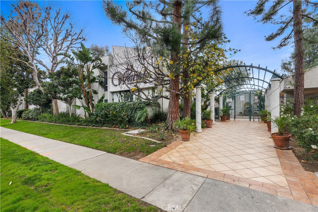 20134 Leadwell Street, Unit 332 Winnetka, CA 91306 - Photo 14 of 14 a front view of a house with yard and green space