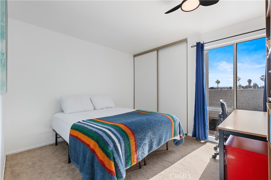 20134 Leadwell Street, Unit 332 Winnetka, CA 91306 - Photo 9 of 14 a bedroom with a bed and window