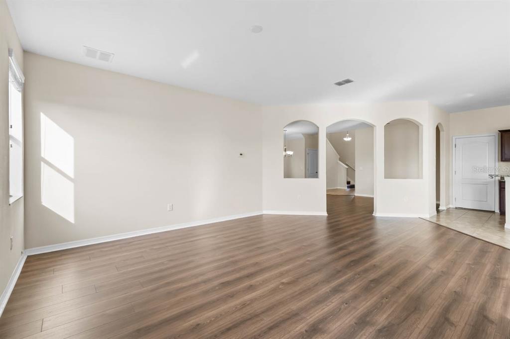 1504 Oak Pond Street Ruskin, FL 33570 - Photo 12 of 76 a view of an empty room with wooden floor and a window