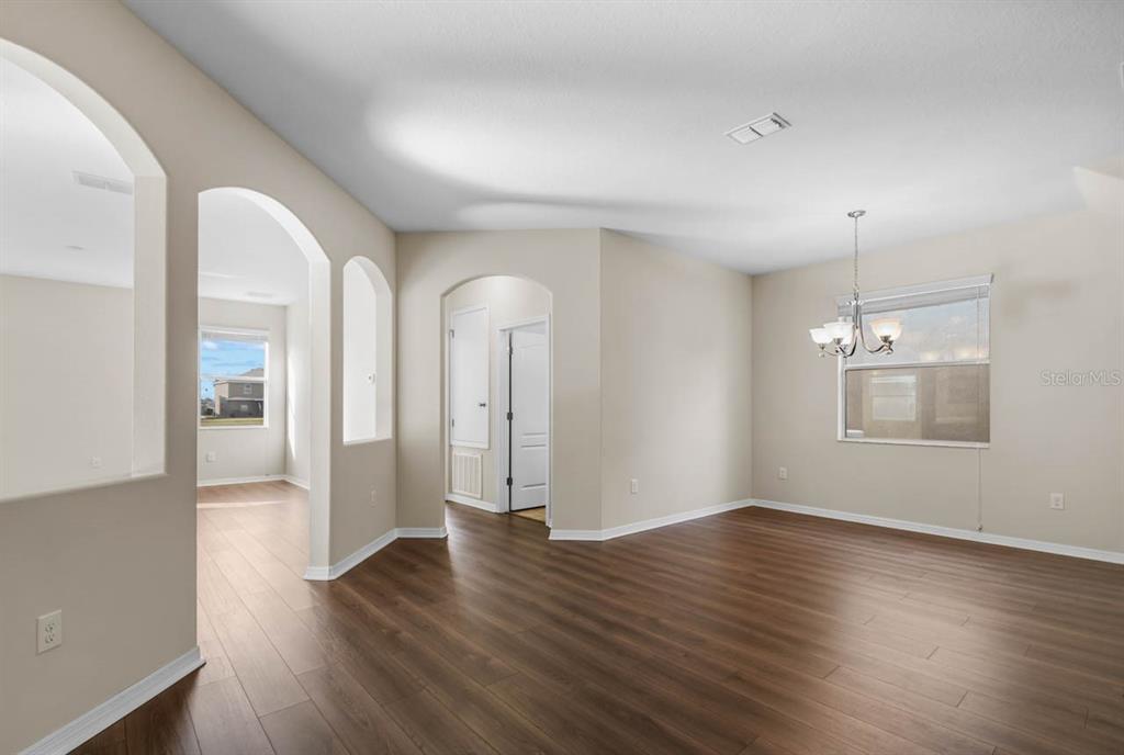 1504 Oak Pond Street Ruskin, FL 33570 - Photo 5 of 76 a view of an empty room with wooden floor and a window
