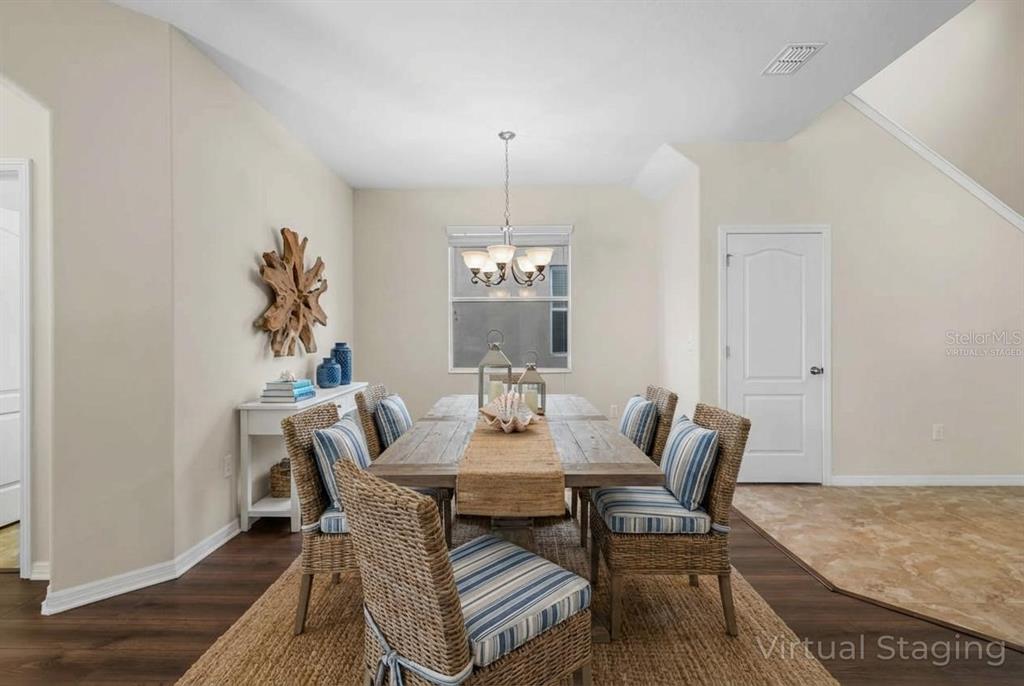 1504 Oak Pond Street Ruskin, FL 33570 - Photo 6 of 76 a dining room with furniture a rug and wooden floor