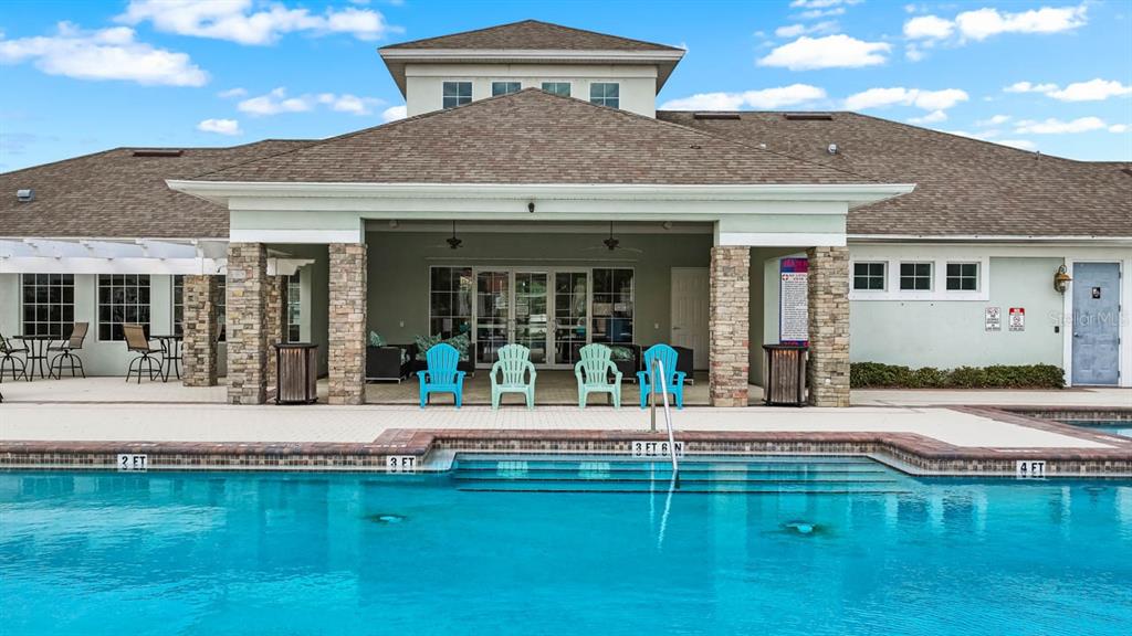 1504 Oak Pond Street Ruskin, FL 33570 - Photo 74 of 76 a front view of a house with swimming pool having outdoor seating