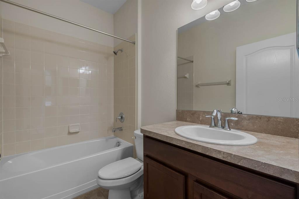 1504 Oak Pond Street Ruskin, FL 33570 - Photo 9 of 76 a bathroom with a granite countertop sink a toilet and shower