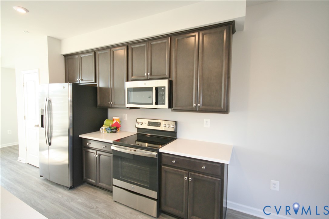 13226 Coalfield Station Lane Midlothian, VA 23114 - Photo 4 of 35 a kitchen with stainless steel appliances granite countertop a refrigerator and a sink