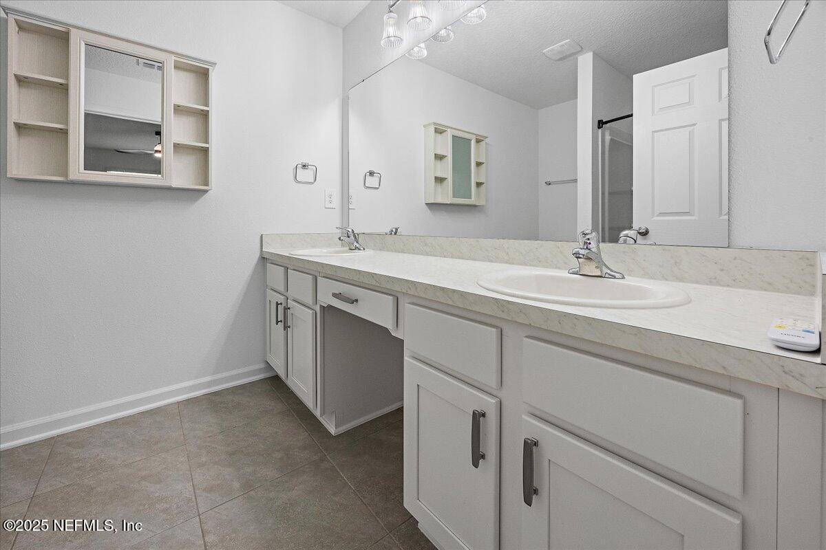 48 Barley Street St. Augustine, FL 32092 - Photo 13 of 24 a spacious bathroom with a sink and a mirror