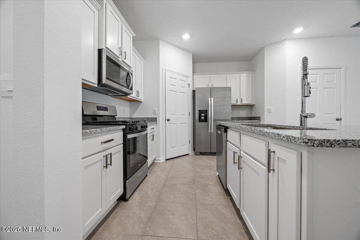 48 Barley Street St. Augustine, FL 32092 - Photo 4 of 24 a kitchen with stainless steel appliances a refrigerator sink and stove
