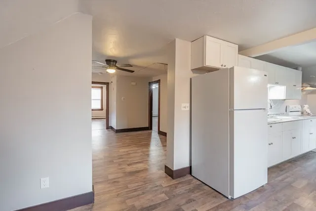 a view of a kitchen with a refrigerator and a stove top oven