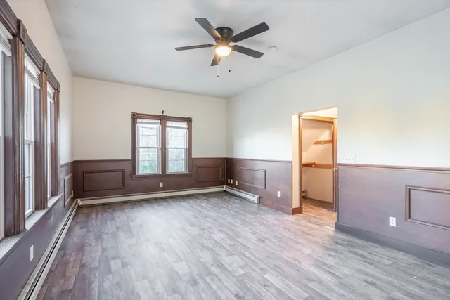 a view of workspace with wooden floor and ceiling fan