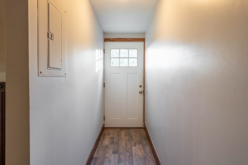 85 East Main Street, Unit 3 West Brookfield, MA 01585 - Photo 4 of 25 a view of an empty room with wooden floor and a window