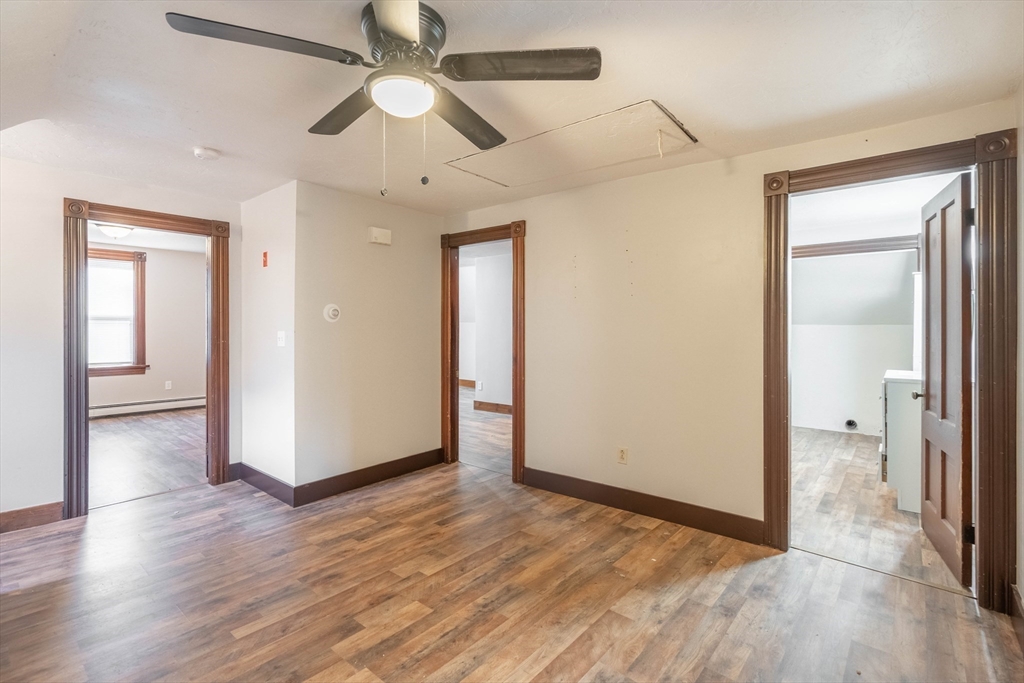 85 East Main Street, Unit 3 West Brookfield, MA 01585 - Photo 8 of 25 an empty room with wooden floor a ceiling fan and entryway