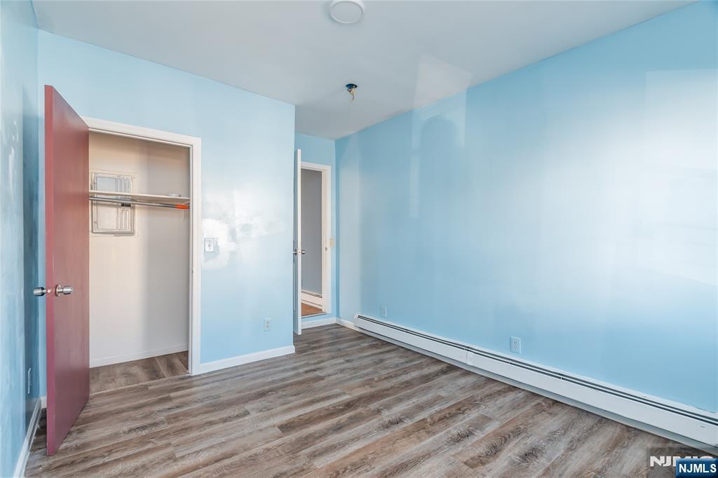 114 Warren Street Paterson, NJ 07524 - Photo 2 of 7 a view of an empty room with wooden floor