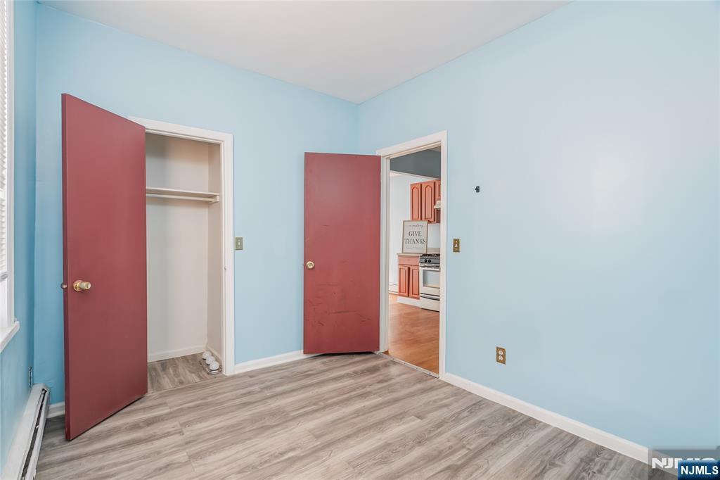 114 Warren Street Paterson, NJ 07524 - Photo 3 of 7 a view of an empty room with closet and wooden floor