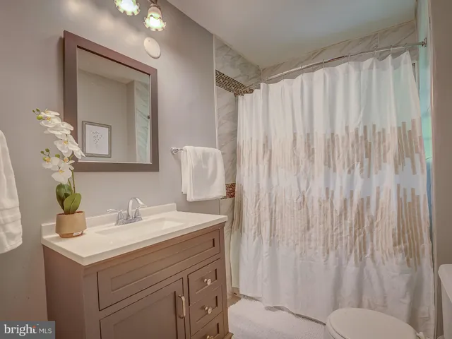 a bathroom with a sink vanity and a mirror