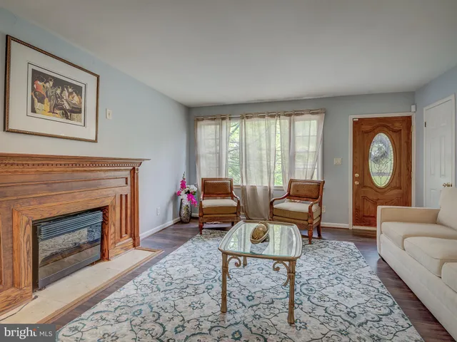 a living room with furniture a window and a fireplace
