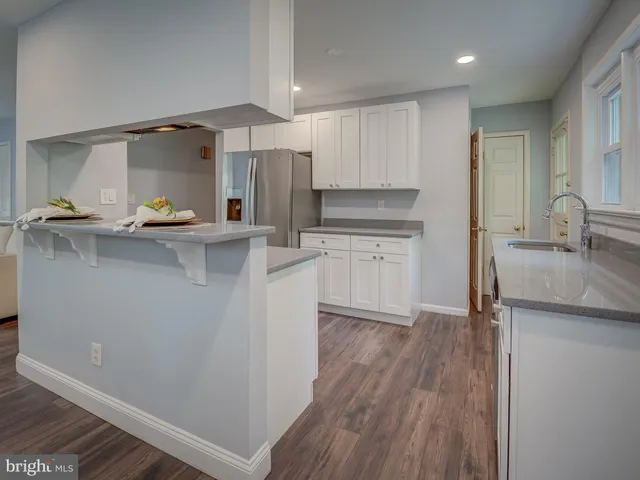 a kitchen with stainless steel appliances a sink stove and refrigerator