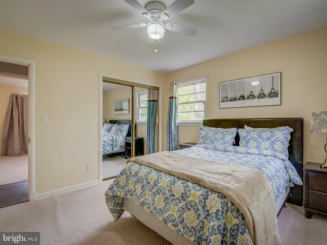 a spacious bedroom with a bed and a chandelier
