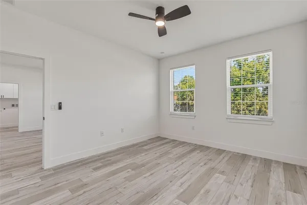 wooden floor in an empty room with a window
