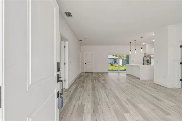 a view of empty room with wooden floor
