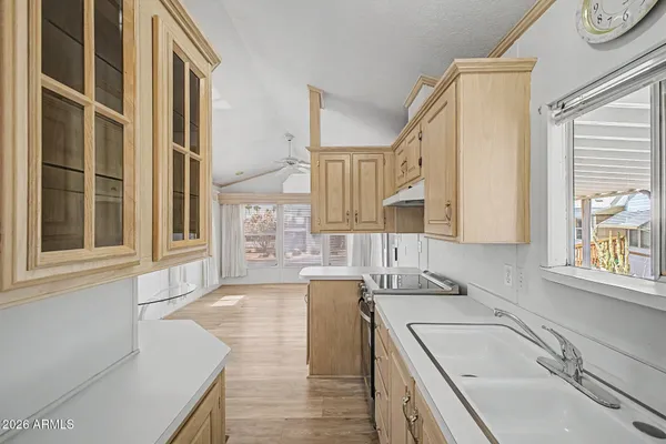 a kitchen with a sink stove and cabinets
