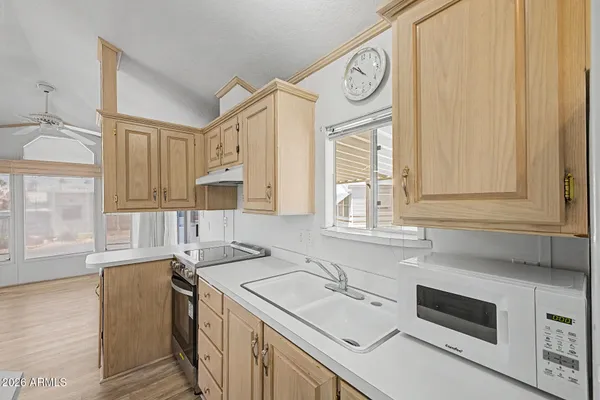 a kitchen with a sink stove and cabinets
