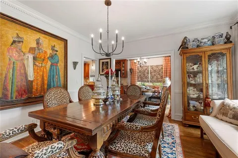 a living room with patio furniture and a chandelier