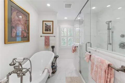 a spacious bathroom with a tub and shower