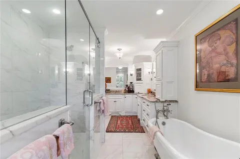 a bathroom with a bathtub and a shower