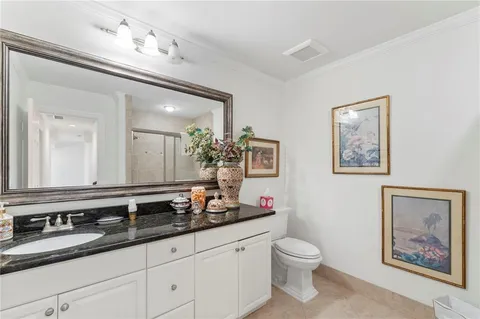 a bathroom with a granite countertop sink and a large mirror