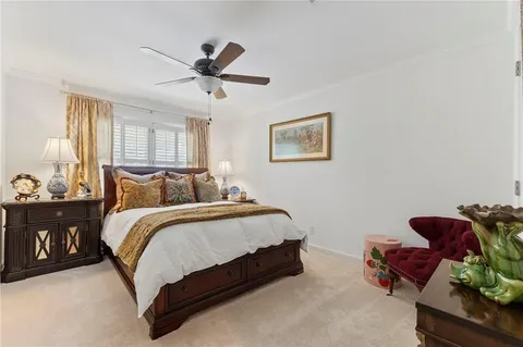 a spacious bedroom with a bed and ceiling fan