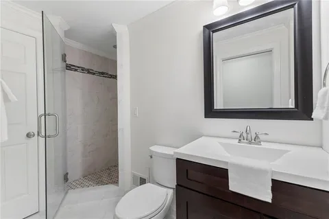 a bathroom with a sink toilet and shower