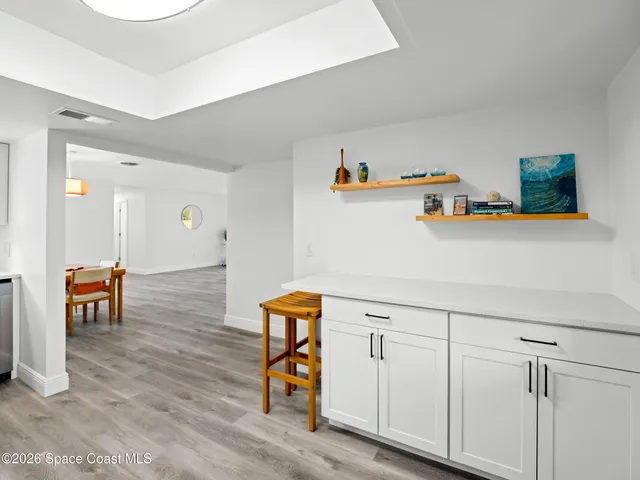 a view of kitchen with furniture and wooden floor