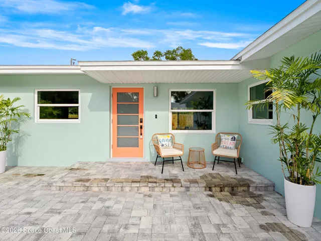 a view of a house with backyard porch and sitting area