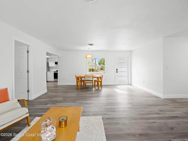 a living room with furniture and large window