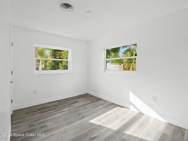 a view of room with window and wooden floor