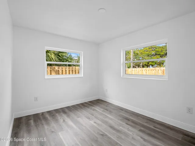 a view of room with window and hardwood