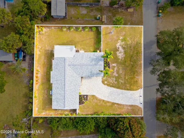 an aerial view of residential house with outdoor space and swimming pool