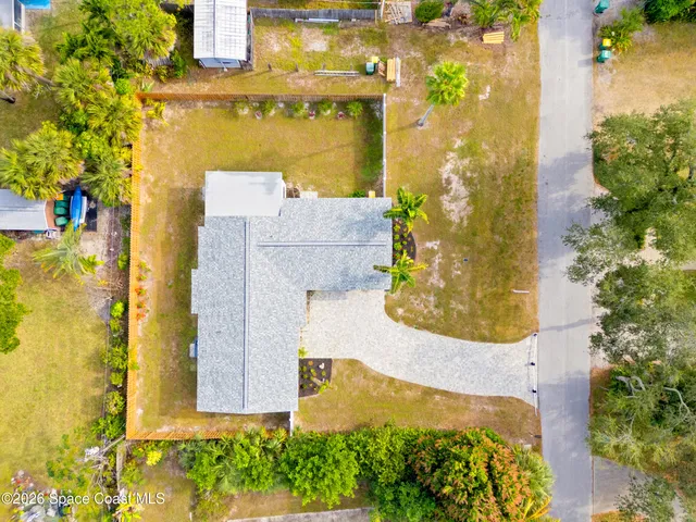 an aerial view of a house with a yard