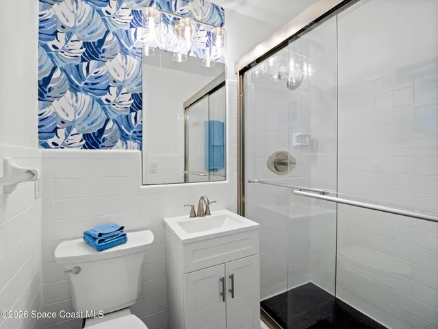 a bathroom with a sink mirror vanity and toilet